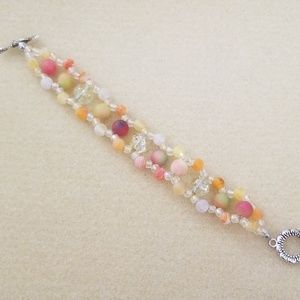 Orange, yellow, red & white beaded bracelet